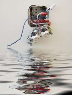 Electrical outlet reflected in floodwater in office-1